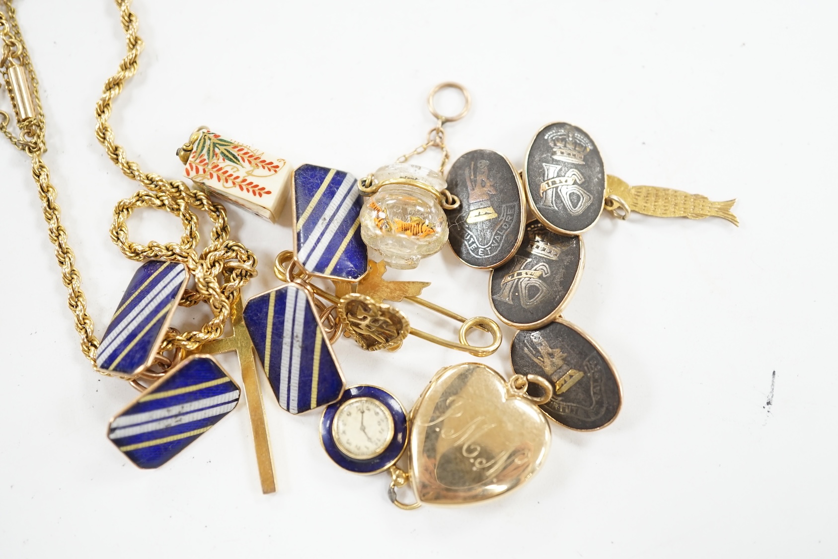 Sundry jewellery including a pair of 14k cufflinks, pair of 9ct cufflinks, a yellow metal rope twist chain with 9ct gold cross pendant, a 9ct gold heart shaped locket and six other items. Condition - poor to fair